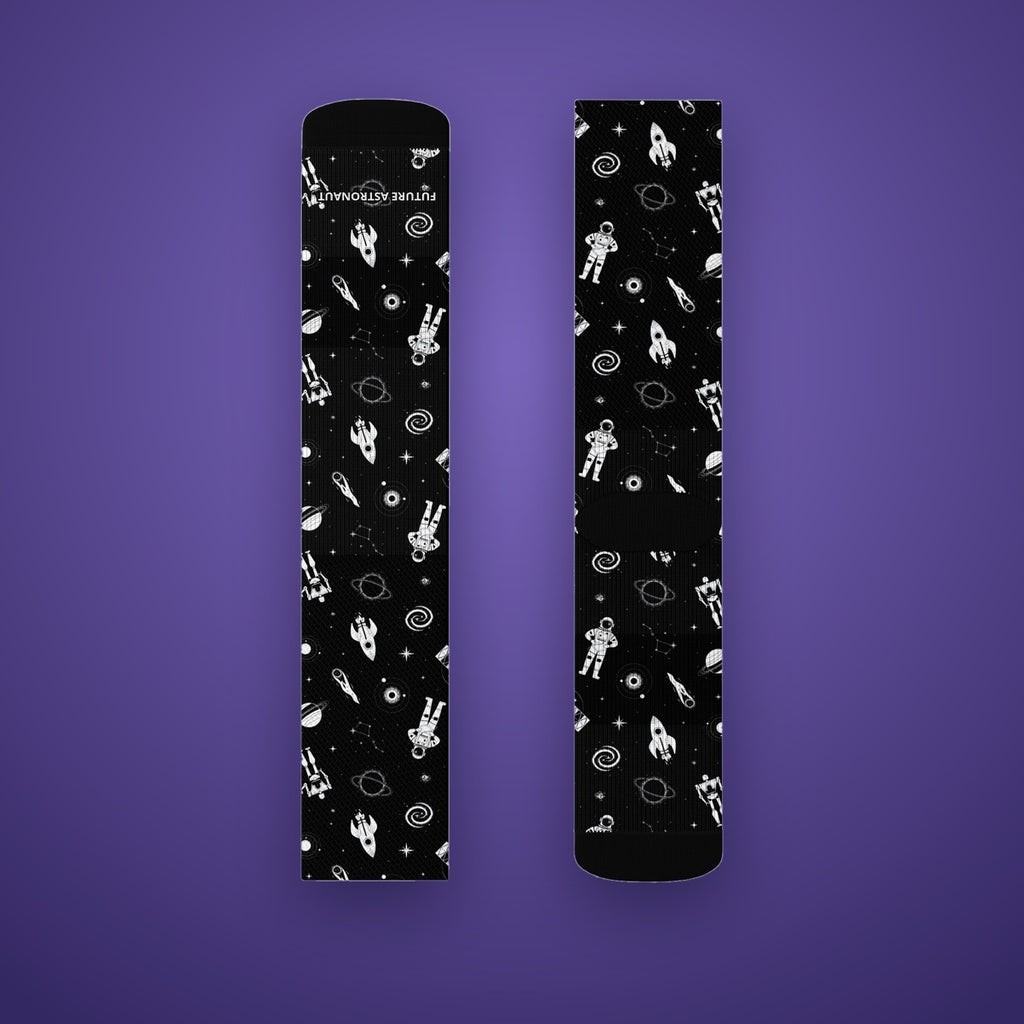Astronaut Crew Socks on Future Astronaut branded background, white astronauts, rockets and planets on black
